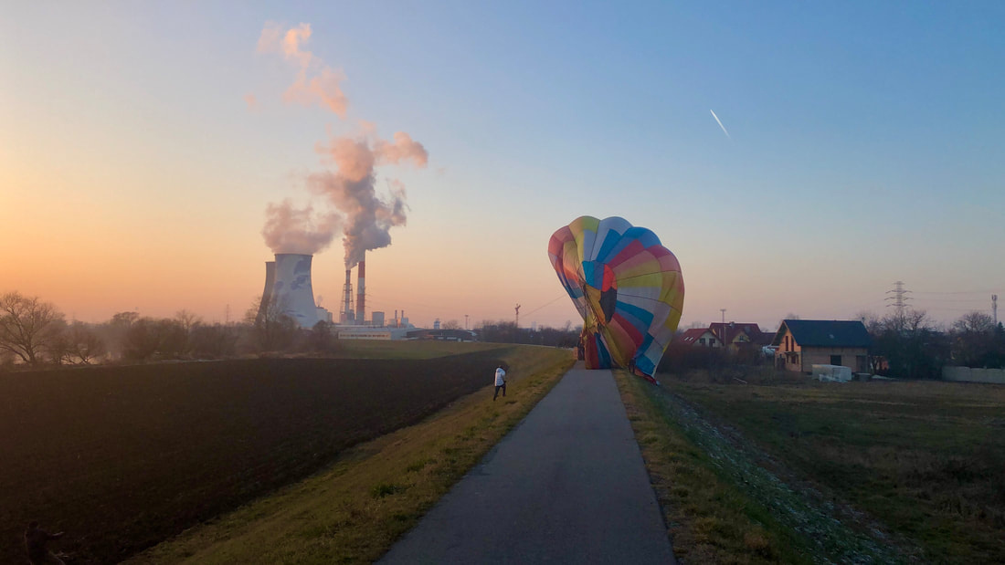 Sunset Balloon over the Vistula River A hot air balloon drifting over the Vistula river at dusk seen from the riverside cycling path.