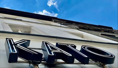 Colorful neon sign in downtown Katowice marking the start of the intercity cycling route.
